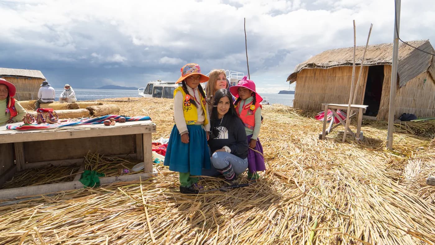 A Uros family welcoming visitors on their reed island