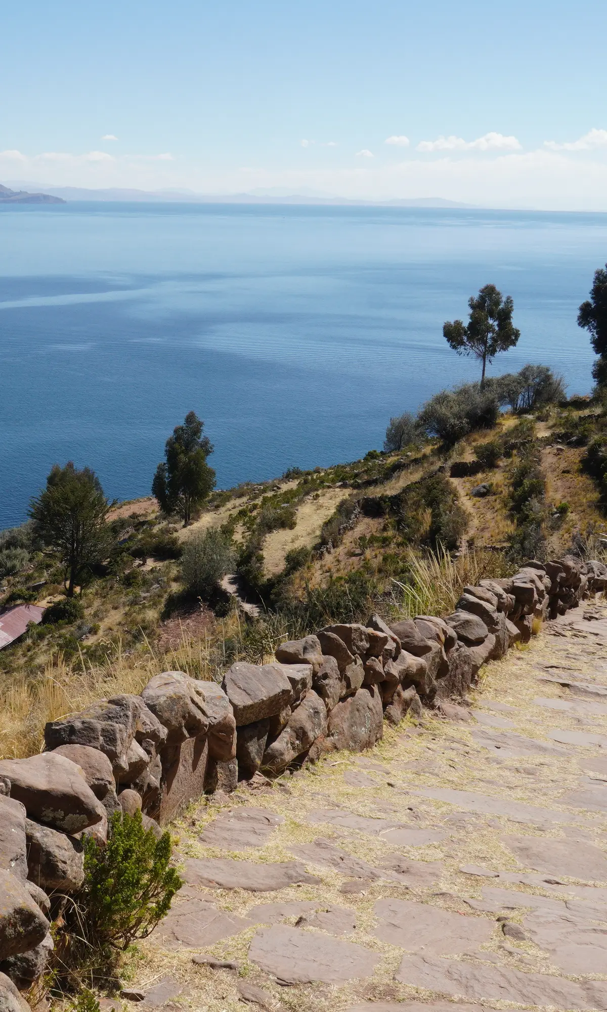 Kayak at sunset on Lake Titicaca, the hills lit up by the last sun